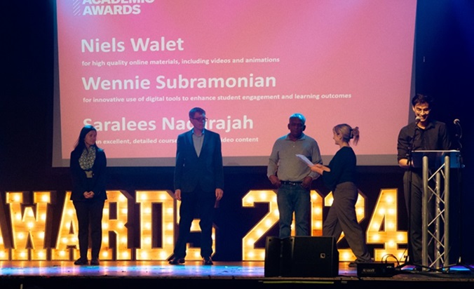 Image of Niels Walet, Wennie Subramonian and Saralees Nadarajah receiving an award