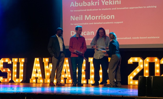 Image of Neil Morrison and Duncan Hill receiving an award at student union awards